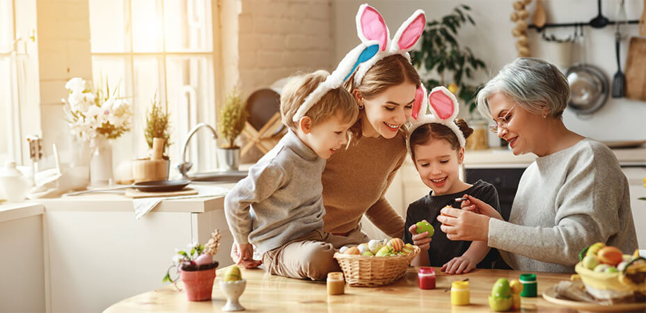 family wearing bunny ears are gathered by the table.